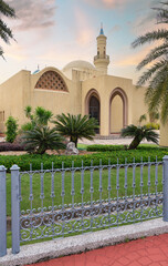 Ash Shaliheen Mosque, with its remarkable architecture and picturesque surroundings in Bandar Seri Begawan, Brunei Darussalam, stands out against the backdrop of a sunset sky, framed by balustrade