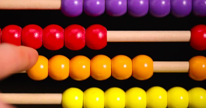 colorful wooden beads on abacus for children's play, wooden children's abacus for learning and development, closeup