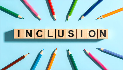 Inclusion Word with Wooden Cubes and Colored Pencils on Sky Blue Background