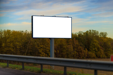 White billboard along the highway. Background for design and advertising.
