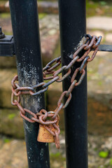 Close-up of rusty padlock on fence