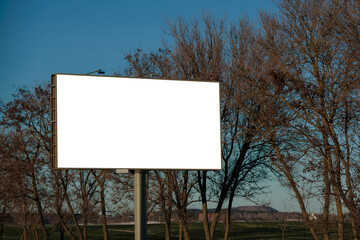 Fototapeta premium White billboard along the highway. Background for design and advertising.