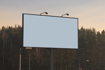 Background for design, white billboards on city streets and along roads in the summer day