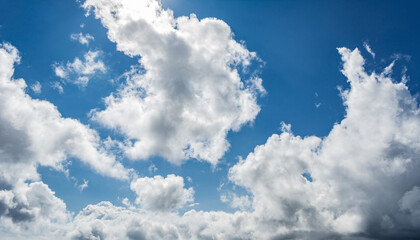 White clouds scattered around a vivid blue sky forming a circular opening that creates a dynamic...