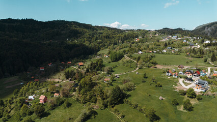 Rural houses and farmlands spread across rolling hills near Zaovine Lake in Tara National Park,...