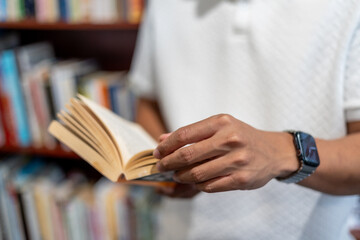 man reading book at home