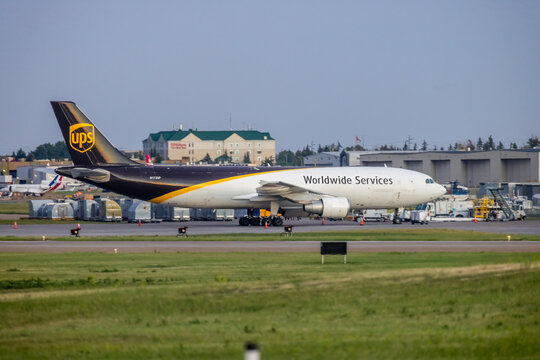 Calgary, Alberta, Canada. Jun 17, 2025. A UPS Airlines cargo aircraft, an Airbus A300, is captured on the tarmac, ready for its next "Worldwide Services" delivery, under a clear sky.
