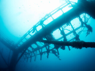 wreck of the submerged structure of an abandoned fish farm sunk in the sea, concept of scuba diving...