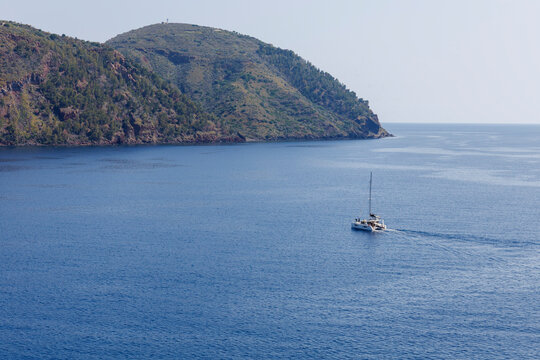 View of a catamaran sailing towards the port of Pignataro, Lipari