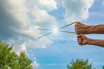 Dowsing with metal indicator L rods in hands. Modern dowser tool. Pair of Divining rods for...