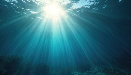 Fototapeta premium Underwater view, sunlight rays. Blue ocean, deep sea water. Bright sun beams through the water surface. Nature, marine life with a focus on the sun light and a play of lights and shadows.