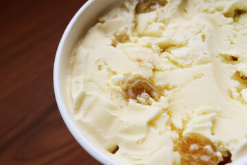 Closeup of mouthwatering rum raisin ice cream in a cup