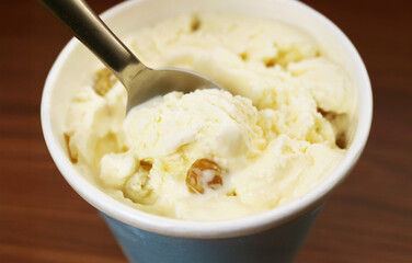 Closeup of spoon scooping delectable rum raisin ice cream