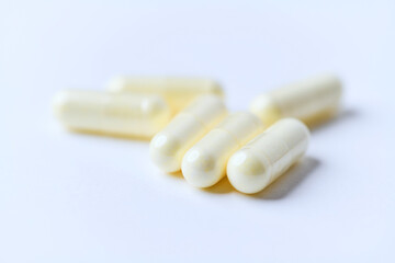 Alpha-lipoic acid capsules. Paper background. Soft focus. Close up. Copy space.	