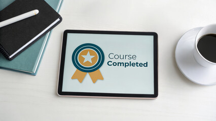 Online learning certification program concept. Course completion certificate displayed on a tablet with coffee and notebook.