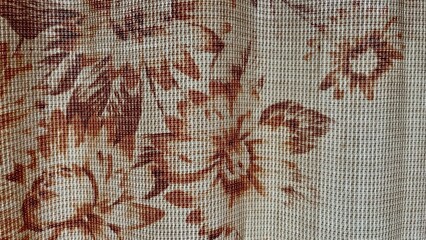 close-up of floral brown and beige woven fabric with textured grid pattern and natural light, ideal...