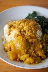 Nasi Padang, Indonesia, captured on June 16, 2025. A traditional Minangkabau rice dish served with a variety of flavorful side dishes such as rendang, vegetables, sambal, and curry sauces.
