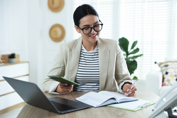 Travel agent with passport and ticket at wooden table in office