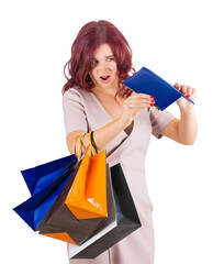 Shocked and disappointed young woman turning around her empty wallet, shaking the cash remaining. Female has spent all money on shopping. Sale season shopaholic problems