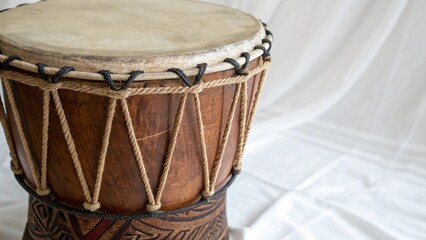 Close-up of a traditional wooden drum top surface with rope tension details
