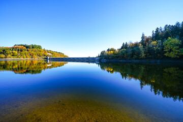 Obraz premium View of the Oleftalsperre Dam and the surrounding landscape. Nature at the lake near the Eifel National Park near Hellenthal in the Hohes Venn-Eifel Nature Park. 