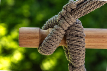 Attaching a Brazilian string swing to a wooden mounting beam, method of hanging the swing