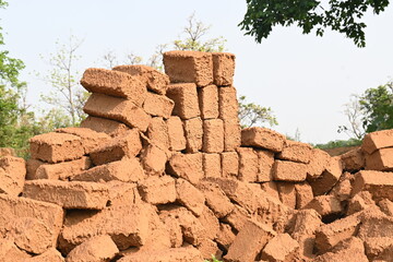 Raw clay bricks have soaked in water.
Sun dried mud bricks, ruined by getting soaked in rain water....