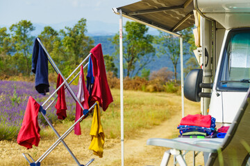 Clothes hanging to dry outdoors by camping car. Caravan vacation.
