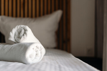 Cozy hotel bedroom with fresh towels and comfortable bedding for relaxation