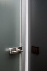 Modern door handle with minimalist design in contemporary apartment interior