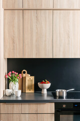 Modern kitchen interior with black countertop and stylish decor elements