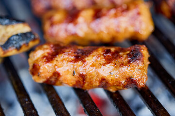 (Mici), traditional Romanian meat dishes on a grill during the cooking