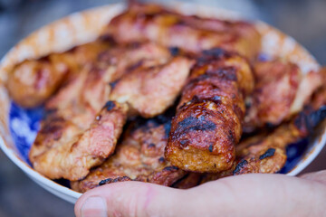 a plate of grilled ( mici ) meatballs, traditional Romanian food