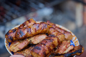 a plate of grilled ( mici ) meatballs, traditional Romanian food