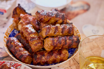 a plate of grilled ( mici ) meatballs, traditional Romanian food