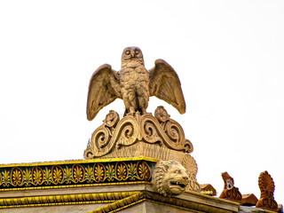 Statue of Athena's owl atop the National Academy roof in Athens, Greece, symbolizing wisdom and knowledge in classical mythology. Space for text and logo.