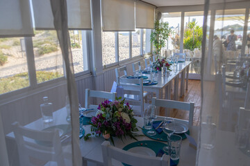 Wedding reception tables decorated with flowers overlooking beach