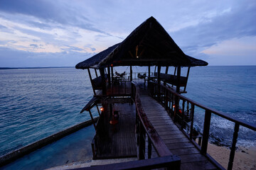Rustic Cliffside Pavilion Overlooking Tranquil Ocean During Dusk