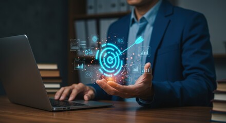 Businessman uses laptop with targeting and data analytics icons hovering over his hand in an office setting