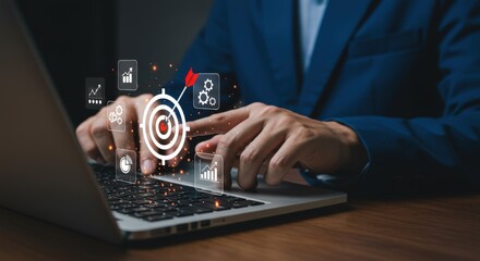 A businessman uses a laptop with digital target and business icons showing strategy and goals