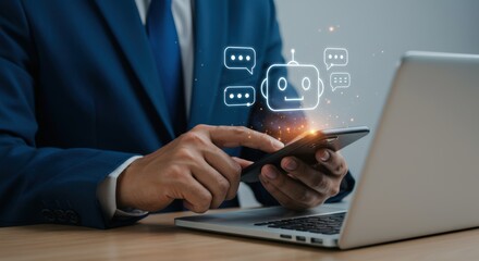 A businessman uses a mobile phone with a chatbot interface next to a laptop