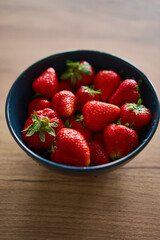 A beautifully vibrant bowl filled with fresh strawberries, showcasing their rich color, sweetness, and natural allure