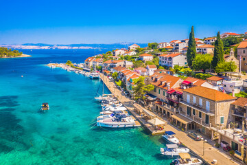 Aerial view of Stomorska, a charming coastal village on Solta Island, Croatia, showcasing its red-roofed houses, turquoise Adriatic waters, and peaceful Mediterranean atmosphere