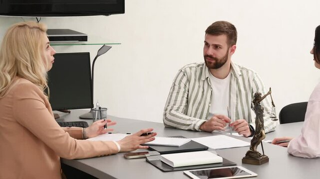 woman lawyer advocate attorney with client couple in office work, legal consultation, paperwork. The couple signs a prenuptial agreement. The spouses get divorced and divide their property