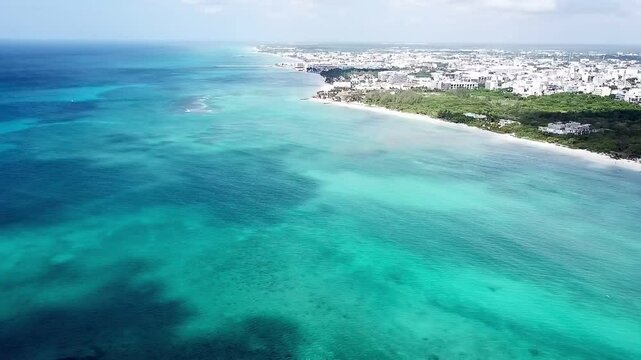 Drone video of the Caribbean Sea and the city of Playa del Carmen from above with turquoise water and white sand beach