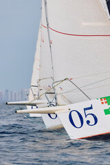 Sailing regatta in the Gulf of Finland at sunset, few sailing yachts competing in a race, splashing...