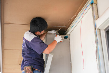 Repairman Fix Air Conditioning Systems, Technician Installing Indoor Air Conditioner Unit, Man on Ladder Working on Wiring in a Home