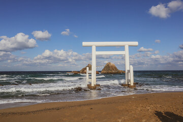 White Torii Gate and Meoto Iwa Couple Rocks in Itoshima, Japan