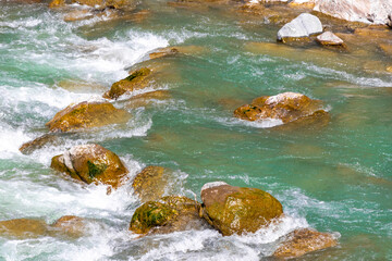 River steam Inn with rocks nature between mountains in Tyrol Austria.