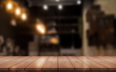Empty wooden table top with lights bokeh on blur restaurant background.